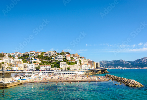 Fototapeta Naklejka Na Ścianę i Meble -  General view of the Prophet beach in Marseille, France, a very popular family beach located on the Kennedy corniche, on a hot and sunny spring day.