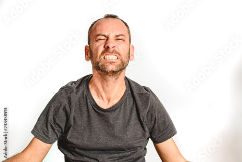Man in studio with effort face, model expressions isolating white background