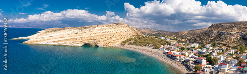 Fototapeta Naklejka Na Ścianę i Meble -  Aerial view of Matala beach on Crete island with azure clear water, Greece, Europe