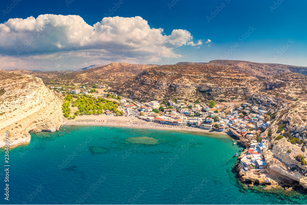 Aerial view of Matala beach on Crete island with azure clear water, Greece, Europe