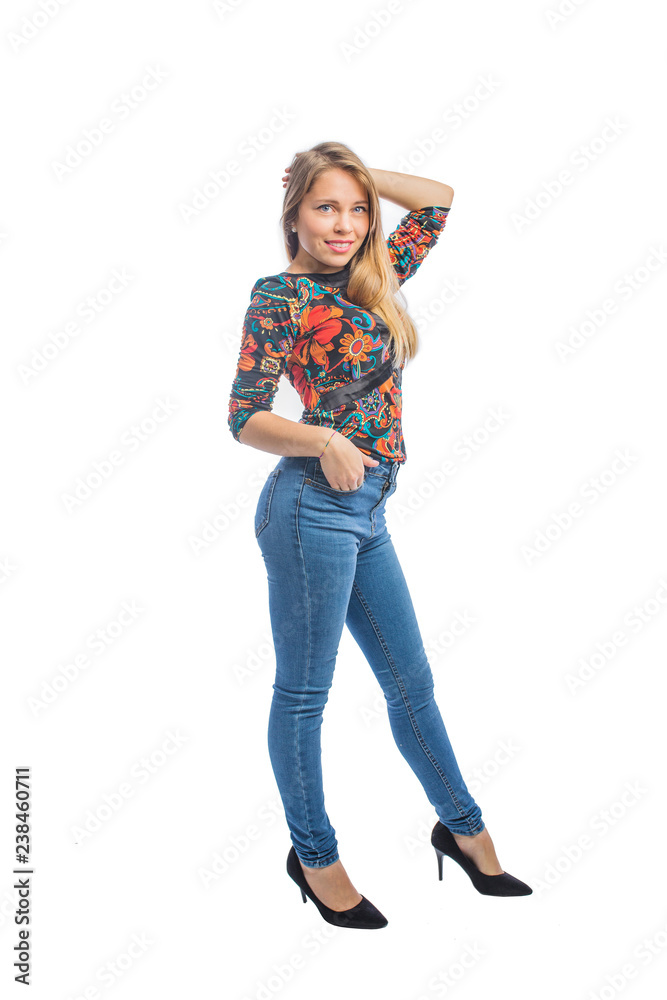 Beautiful young woman with long blond hair in jeans, a blouse and shoes posing with one hand on her head and the other hand in a jeans pocket, profile photo. Beautiful young woman with long blond hair in jeans, a blouse and shoes posing with one hand on her head and the other hand in a jeans pocket, profile photo.