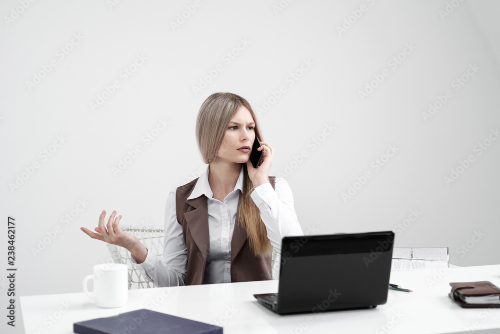 The girl office worker is annoyed. Shouts on the phone and outraged. The girl office worker is annoyed. Shouts on the phone and outraged.