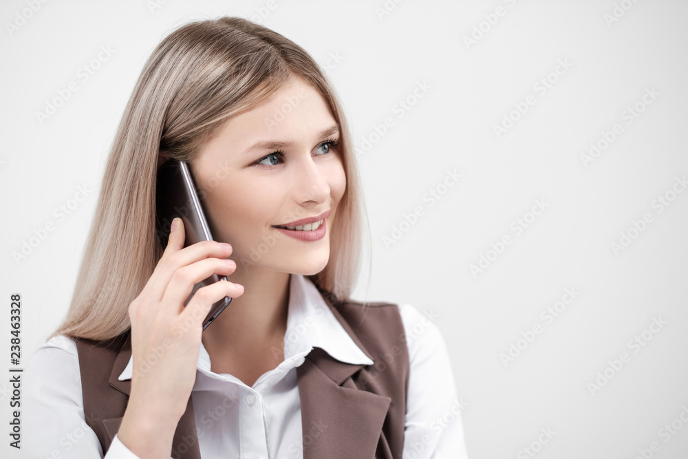 Close-up of the face and lips of a girl talking on a smartphone. Smile and friendly look. Close-up of the face and lips of a girl talking on a smartphone. Smile and friendly look.