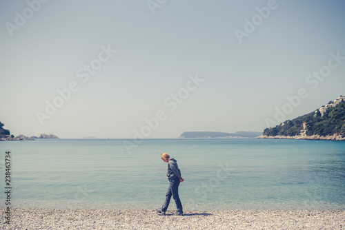 Tourist walking slowly on the beach