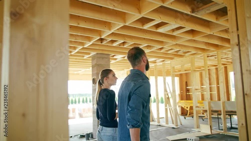 Two young people discussing the construction of a house inside the house. Medium shot. Soft focus