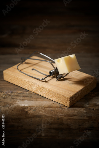 High angle view of wooden mousetrap with cheese on table