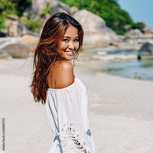 Portrait of a beautiful girl on a summer beach photo