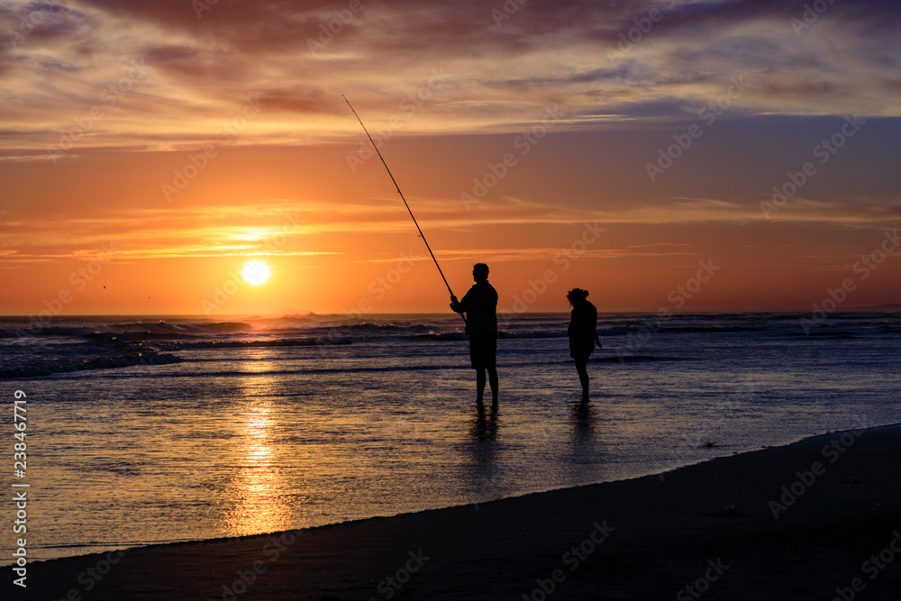 silhouette of fisherman at sunset