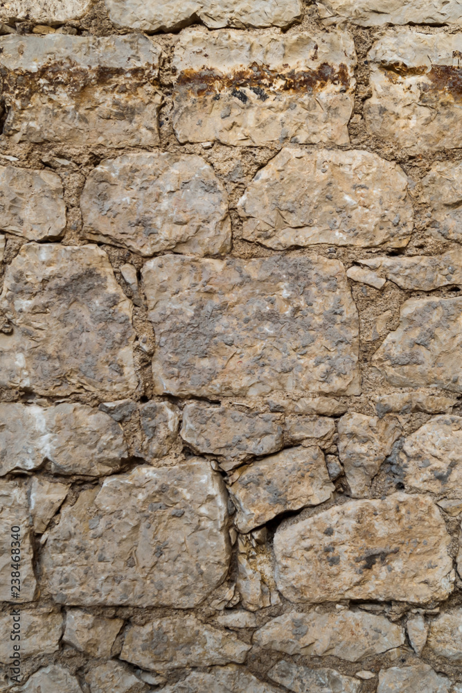 Old stone wall. Construction masonry from different blocks. Stone texture.