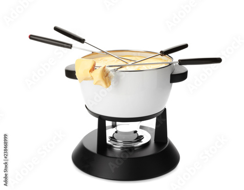 Pot of delicious cheese fondue and forks with bread on white background