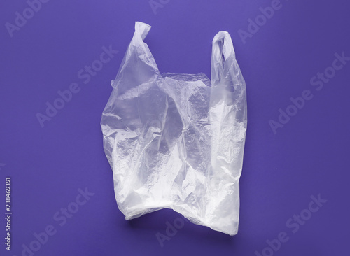 Clear disposable plastic bag on color background