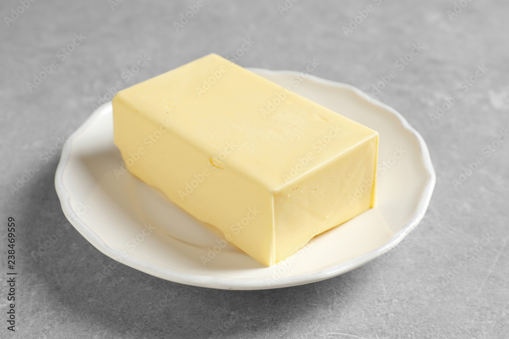 White plate with fresh butter on table