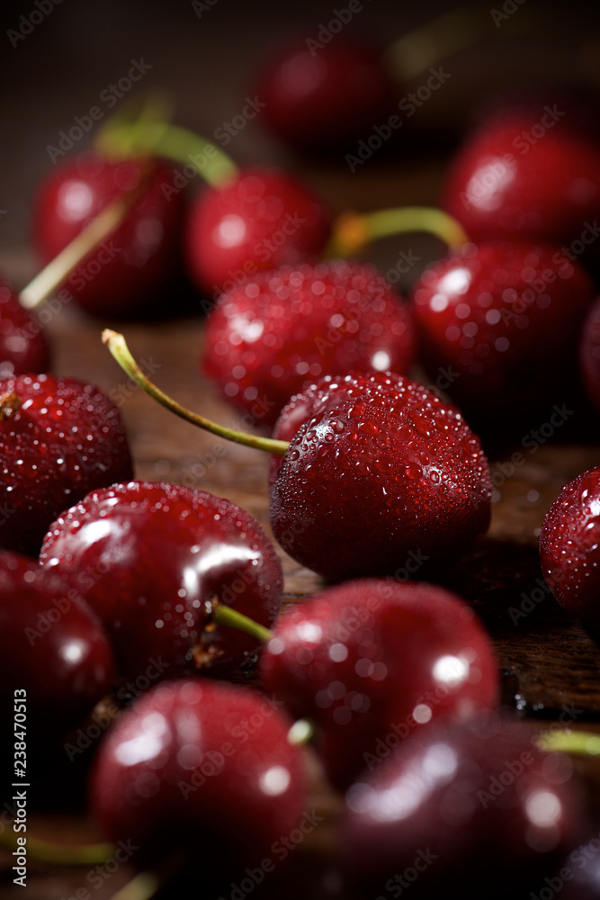 High angle view of wet cherries on wooden table High angle view of wet cherries on wooden table