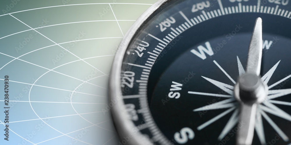 Fototapeta premium Brass antique compass on blue background. Close-up compass.