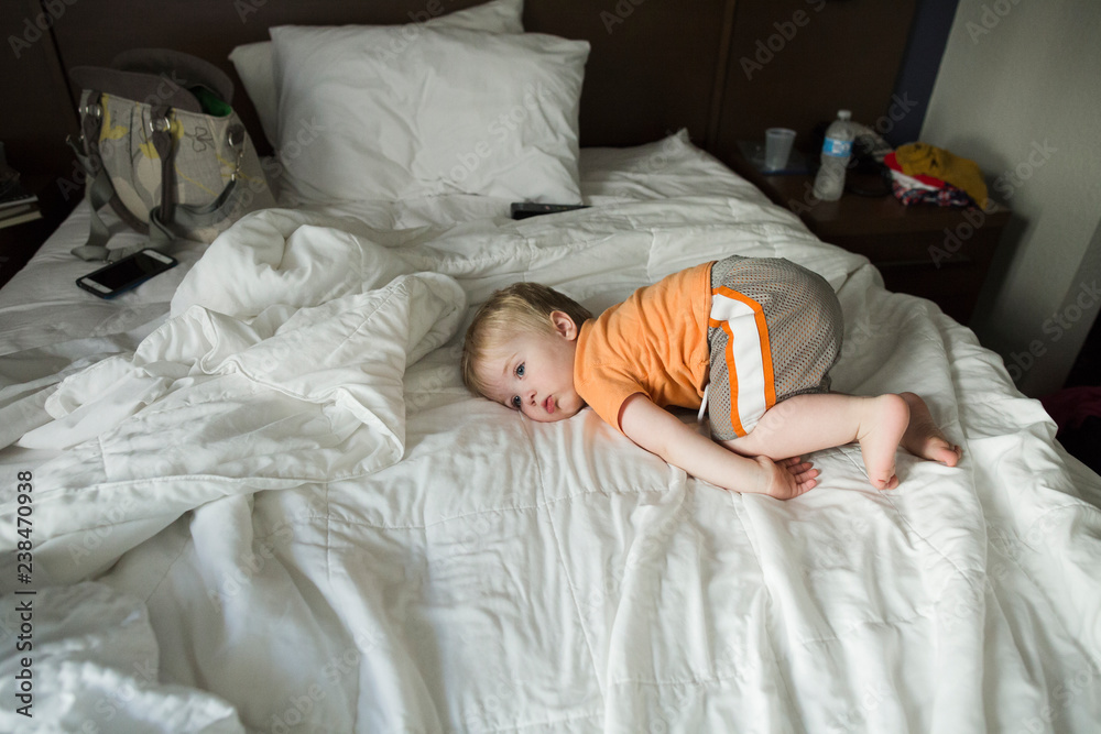 Thoughtful boy lying on bed at home Thoughtful boy lying on bed at home