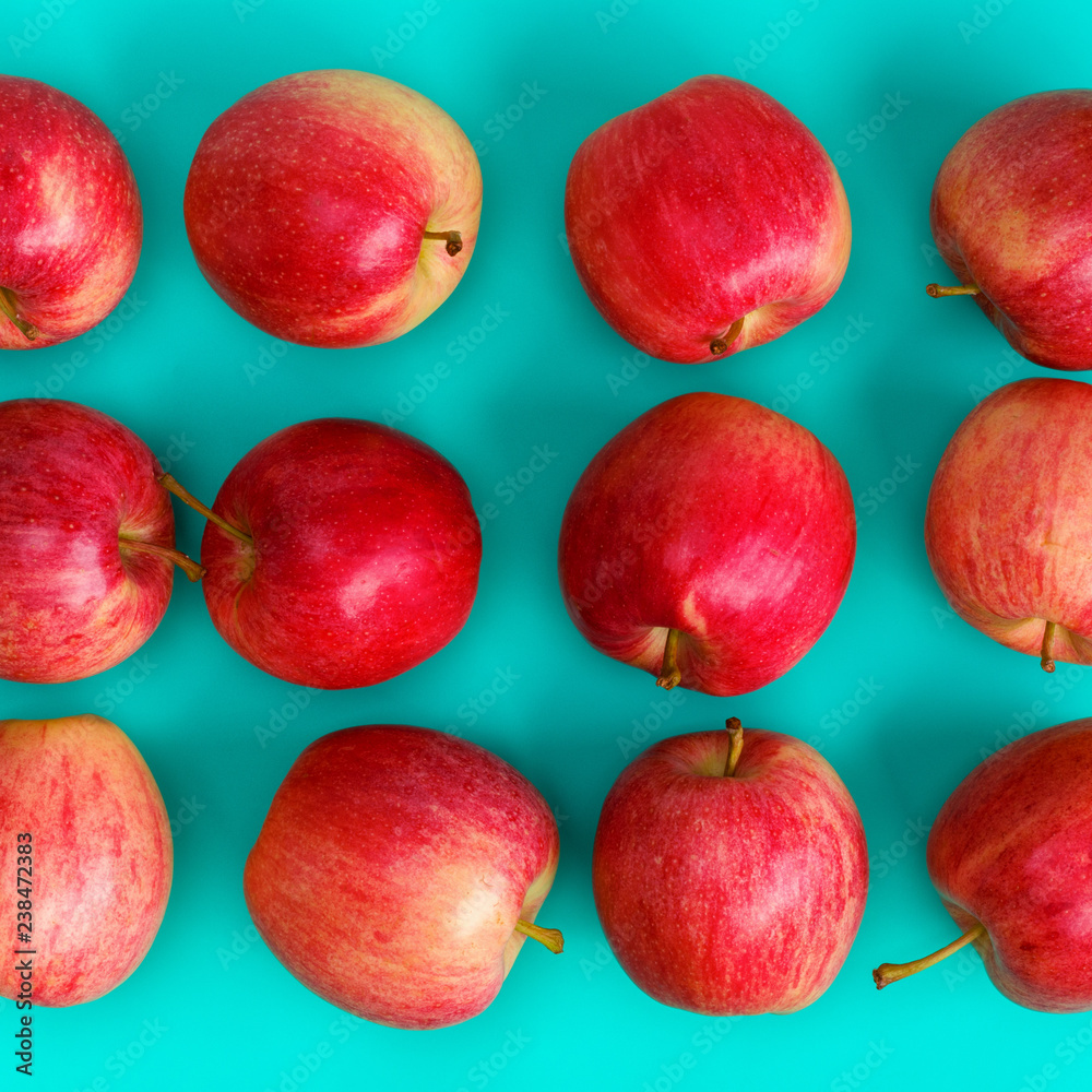 Fruit pattern of red apple on blue background. Flat lay, top view. Pop art design, creative summer concept. Food background. Fruit pattern of red apple on blue background. Flat lay, top view. Pop art design, creative summer concept. Food background.