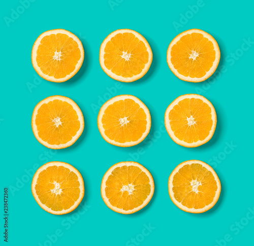 Fruit pattern of orange slices on blue background. Flat lay  top view. Food background.