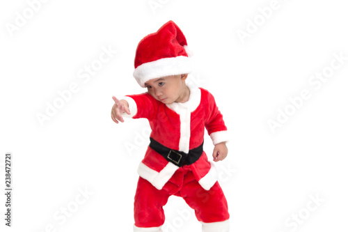 Asian baby boy in a Christmas costume Santa Claus pointing fingers and shows something amazing at the front isolated on white background, Shocked, Surprised cute little boy child in xmas festival
