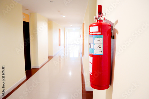 Fire extinguisher install front of the room.Security system concept. © nukies1234