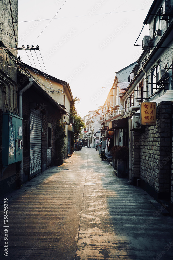 Empty road amidst buildings against clear sky during sunset Empty road amidst buildings against clear sky during sunset
