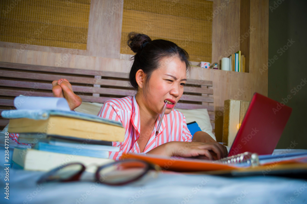 young desperate and tired Asian Korean university student girl feeling overwhelmed and stressed preparing exam studying with laptop computer in stress young desperate and tired Asian Korean university student girl feeling overwhelmed and stressed preparing exam studying with laptop computer in stress