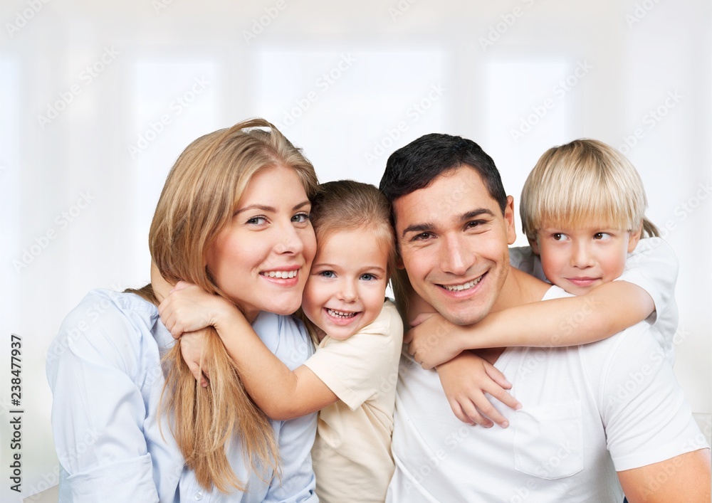 Beautiful smiling family sitting at sofa at home Beautiful smiling family sitting at sofa at home
