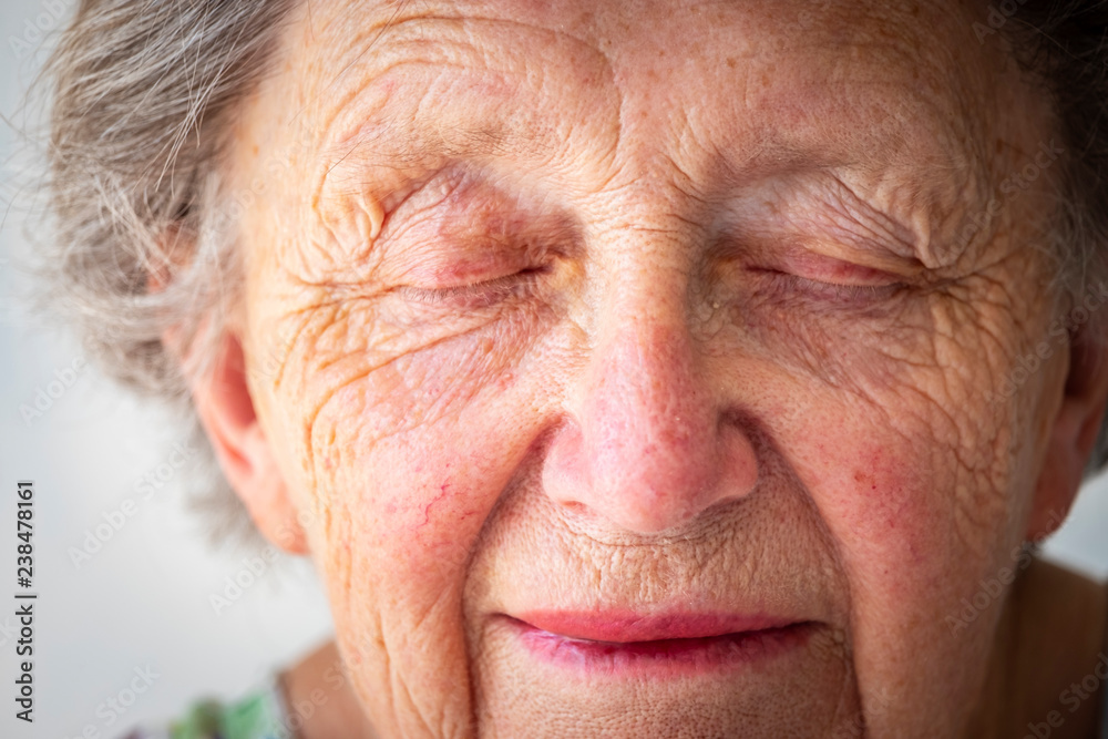 Close-up of sad senior woman with eyes closed Close-up of sad senior woman with eyes closed