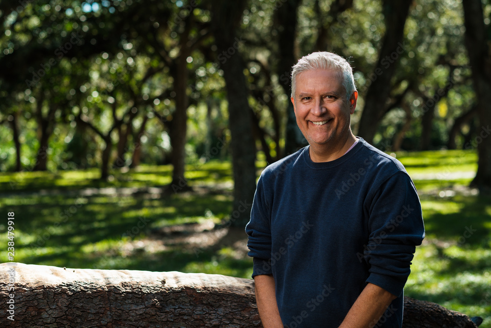 Handsome man outdoors in a park setting Handsome man outdoors in a park setting
