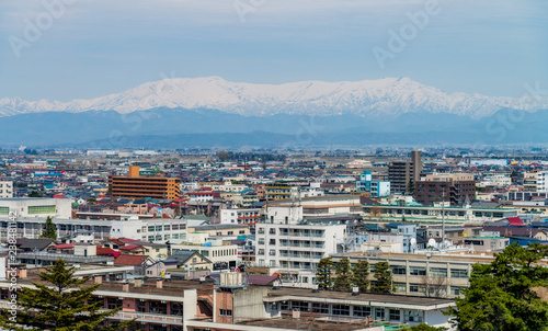 Aerial view of Aizu-Wakamatsu town and snowy mountain behind, Fukushima, Japan.