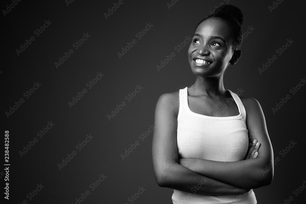 Obraz premium Young beautiful African Zulu woman smiling and thinking in black and white