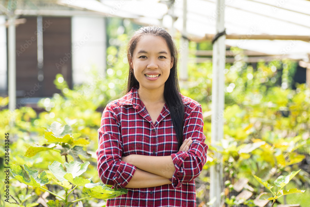 Asian young woman farmer arms crossed in fig fruit garden Asian young woman farmer arms crossed in fig fruit garden