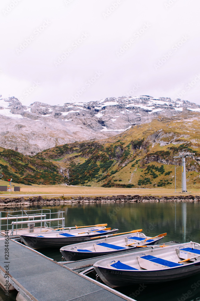 Trubsee lake row boats with Swiss Alps of Engelberg