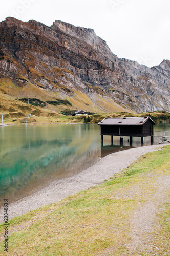 Trubsee lake house with Mount Graustock and Swiss Alps of Engelberg photo