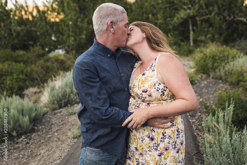 Mature couple kissing in forest
