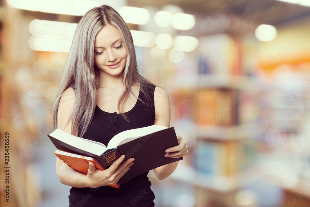 Young smiling woman holding blue notebook Young smiling woman holding blue notebook