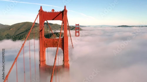 San Francisco Golden Gate Bridge Sticking / Poking Through Thick blanket of Fog - Aerial View / Flyover From Helicopter photo