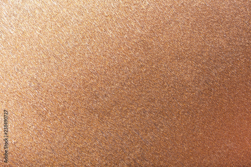 Textural of bronze background of wavy corrugated paper, closeup.