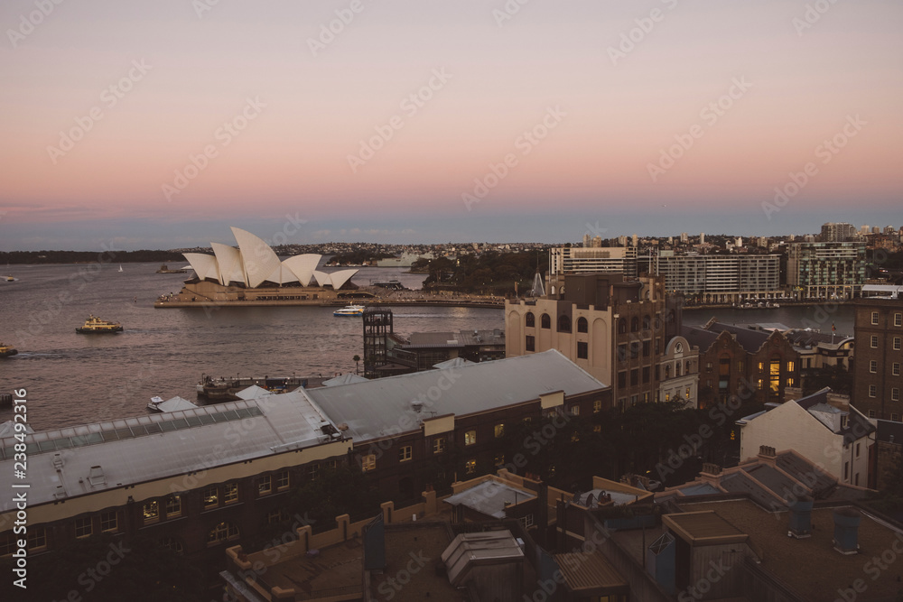 High angle view of cityscape by Sydney Harbor against clear sky during sunset High angle view of cityscape by Sydney Harbor against clear sky during sunset