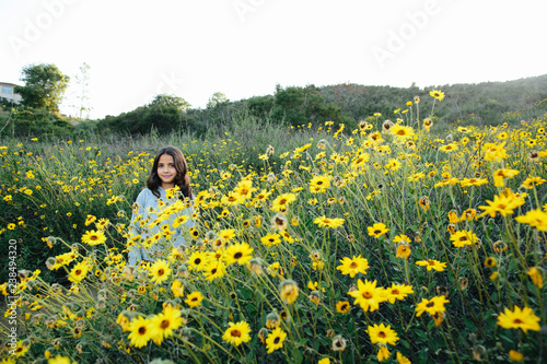 Portrait of girl standing amidst plants against clear sky during sunset photo