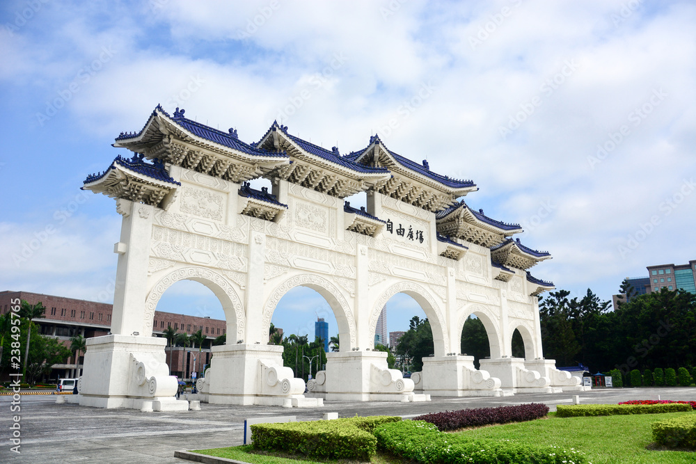 the main gate of national Taiwan democracy memorial hall (Chiang Kai-Shek memorial Hall) in sunny day with blue sky and clound background, (The meaning of the Chinese text is 
