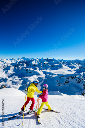 Obraz na płótnie Happy family enjoying winter vacations in mountains . Ski, Sun, Snow and fun. w salonie