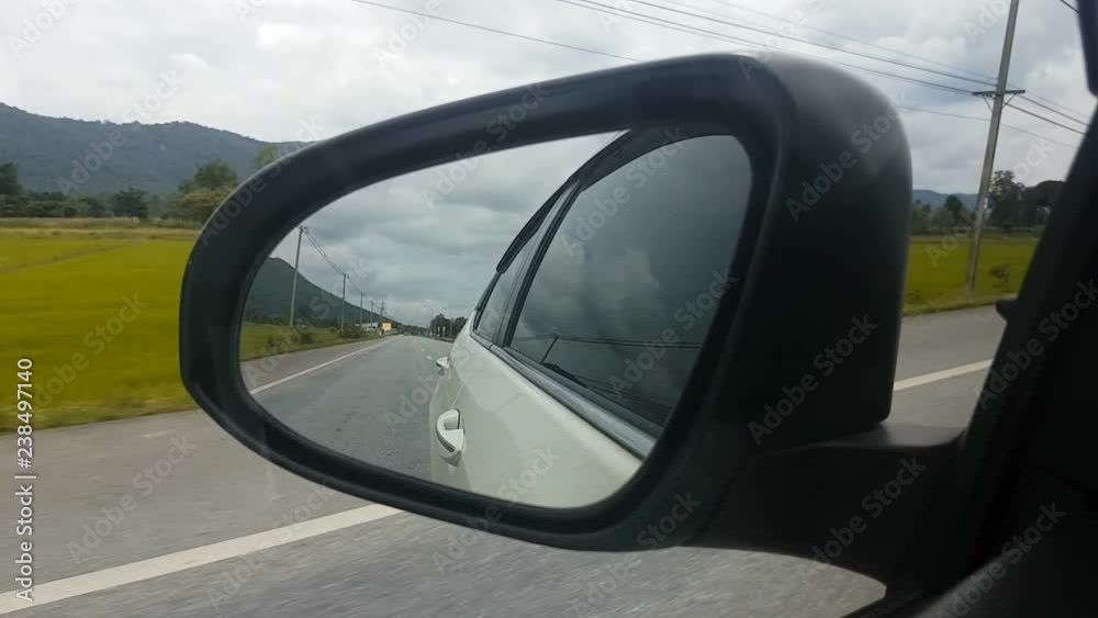 Side mirror of a vehicle driving on the road Side mirror of a vehicle driving on the road