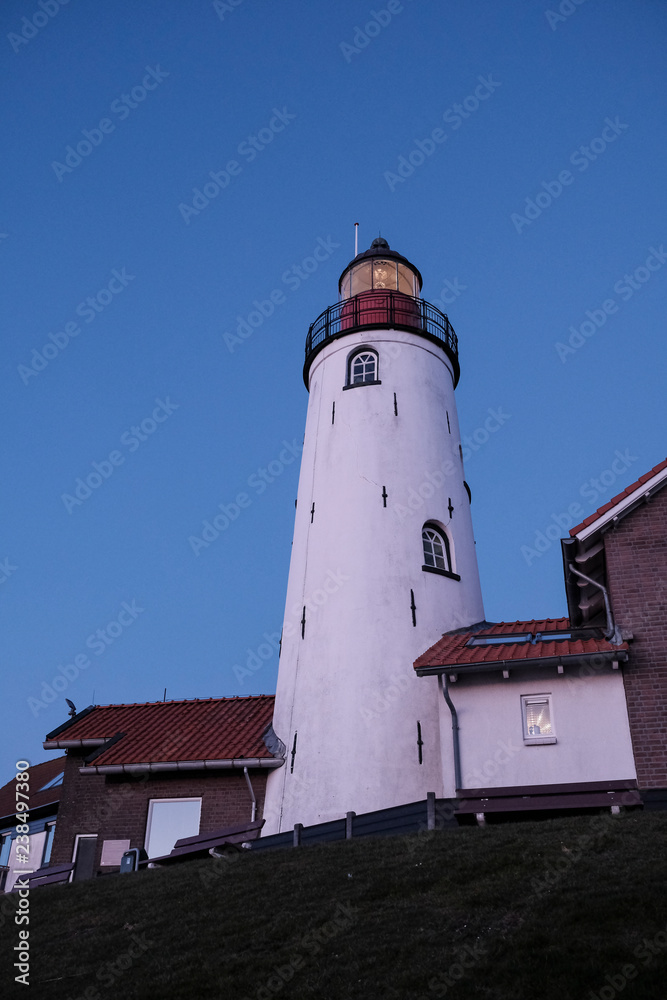 Low angle view of Urk Lighthouse against clear blue sky during sunset Low angle view of Urk Lighthouse against clear blue sky during sunset