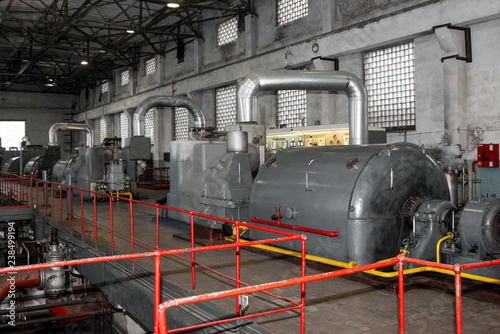 Turbogenerators in old plant. Steam turbine generator. Heat engine to convert steam energy into mechanical work. Industrial equipment photo