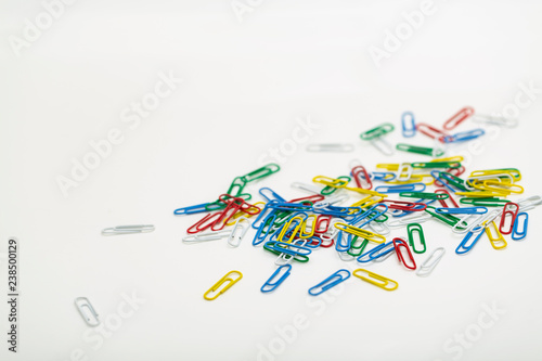 Colored paper clips isolated on white background.