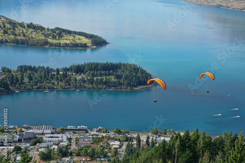 Parasailing thrills over Queenstown New Zealand and the bay.