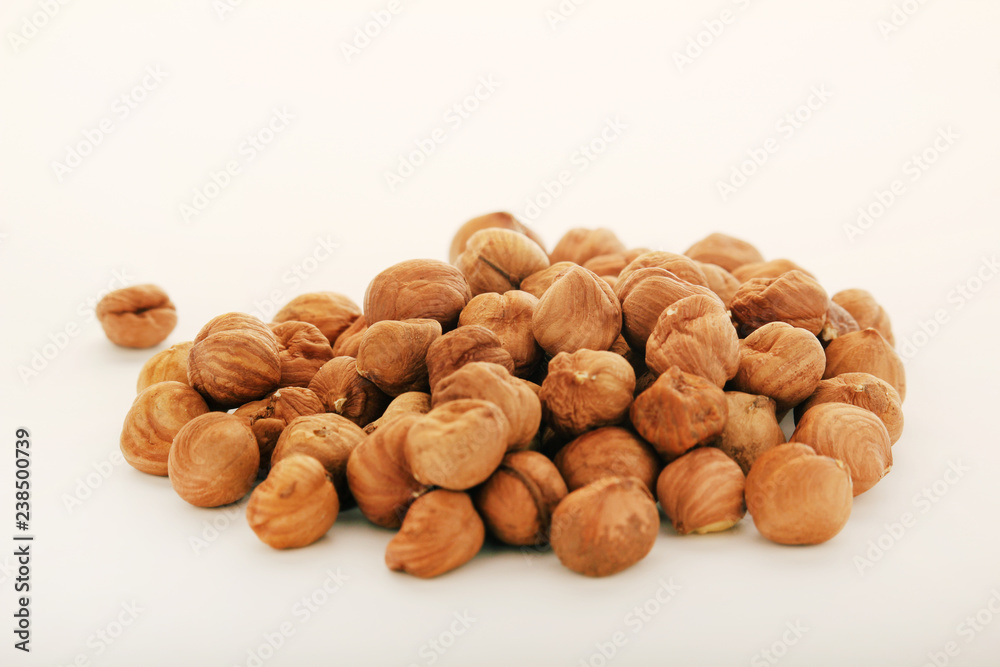 A pile of hazelnuts at white background A pile of hazelnuts at white background