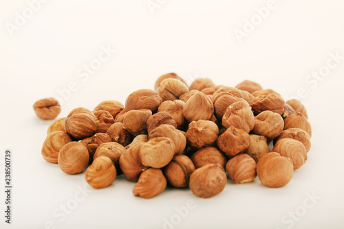 A pile of hazelnuts at white background 