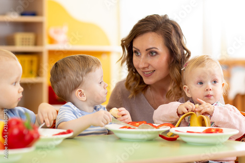 teacher and three preschool...