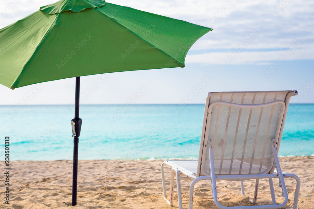 White chairs and umbrella on a beach